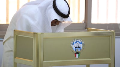 A Kuwaiti man casts his vote during parliamentary elections in Kuwait City. Kuwait is holding its most inclusive elections in a decade, with some opposition groups ending a boycott after the country's royal rulers pledged not to interfere with Parliament. AFP