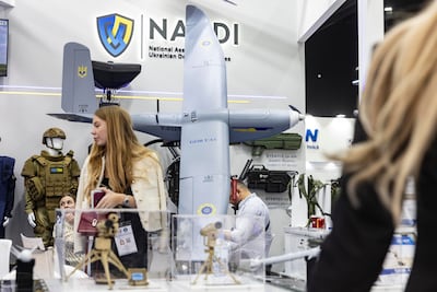 Visitors examine military technology at Ukraine's pavilion at Idex in Abu Dhabi. Antonie Robertson / The National