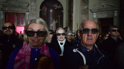 People wearing 3D glasses follow in the church of Sotto il Monte Giovanni XXIII in Milan the broadcast of the canonisation mass of Popes John XXIII and John Paul II on St Peter’s at the Vatican. Oliver Mori / AFP Photo