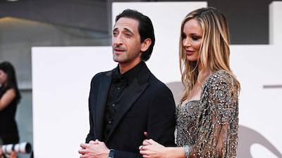 Adrien Brody, in all black, and British stylist Georgina Chapman, in a metallic gown. AFP