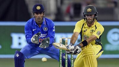 Australia's Glenn Maxwell, right, hits a reverse sweep watched by India's MS Dhoni during their one day international cricket match in Melbourne, Australia, Sunday, January 17, 2016. Andy Brownbill / AP Photo