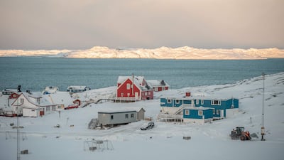The sun rises over the mountains behind the city of Nuuk, Greenland. AFP