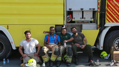Abdulla Hassan, Sultan Ashor, Waleed Issa and Ashraf Khan from the Dubai Fire Station were amongst the first batch of firefighters to arrive on the scene last night. Here they rest after the fire was declared under control on Friday afternoon. Victor Besa for The National