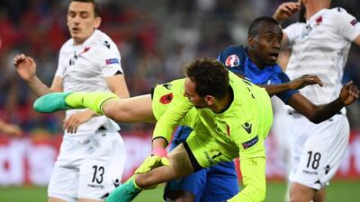 Albania goalkeeper Etrit Berisha jumps for the ball against France's midfielder Blaise Matuidi. Franck Fife / AFP