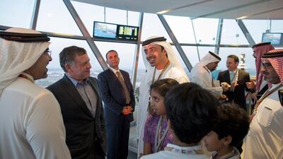 Sheikh Abdullah bin Zayed, Minister of Foreign Affairs, centre, speaks with Prince Salman bin Hamad bin Isa Al Khalifa, Crown Prince and Deputy Supreme Commander of Bahrain, left, King Abdullah of Jordan, second left, and Sheikh Abdullah bin Isa Al Khalifa, right, attend the final day of the 2014 Formula 1 Etihad Airways Abu Dhabi Grand Prix at Yas Marina Circuit. Seen with Sheikh Zayed bin Abdullah bin Zayed, second right, Sheikh Mohammed bin Abdullah bin Zayed, third right, and Sheikha Fatima bint Abdullah bin Zayed, fourth right, lower centre. Ryan Carter / Crown Prince Court — Abu Dhabi