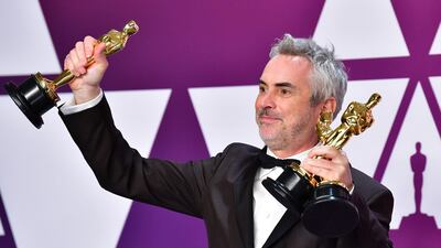 Alfonso Cuaron poses in the press room with his Oscars during the 91st Annual Academy Awards at the Dolby Theatre in Hollywood, California on February 24, 2019. The movie won Best Foreign Film, but was also nominated for Best Picture. AFP