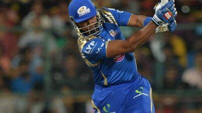Mumbai Indians batsman Kieron Pollard plays a shot, during the 2016 Indian Premier League (IPL) Twenty20 cricket match between Royal Challengers Bangalore and Mumbai Indians, at The M. Chinnaswamy Stadium in Bangalore on May 11, 2016. Mumbai Indians are chasing a target of 152 runs set by Royal Challengers Bangalore. (AFP/MANJUNATH KIRAN)