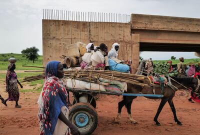 FILE PHOTO: A Chadian cart owner transports belongings of Sudanese people who fled the conflict in Sudan's Darfur region, while crossing the border between Sudan and Chad in Adre, Chad. Reuters
