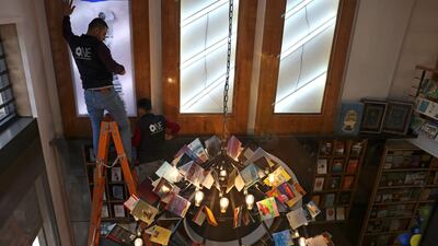 Workers prepare for the opening of the new Samir Mansour bookshop that was destroyed during last year's 11-day war between Israel and the Palestinian Hamas movement, in Gaza City. Mansour's beloved bookshop has been rebuilt and restocked following an international fundraiser.