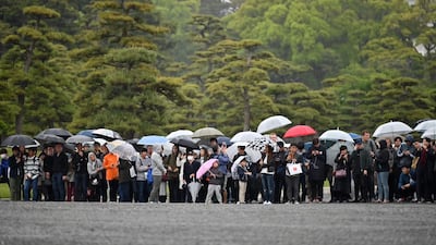 People gather outside the Imperial Palace, where the abdication ceremony for Japan's Emperor Akihito is taking place, in Tokyo. Emperor Akihito is handing over the Chrysanthemum Throne to his eldest son, 59-year-old Crown Prince Naruhito, in a series of solemn rituals that also usher in the new imperial era named "Reiwa" -- meaning beautiful harmony -- that will last throughout the new monarch's reign. AFP