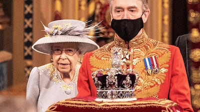 Queen Elizabeth walks behind the Imperial State Crown as they pass through the Royal Gallery, before delivering the Queen's Speech. AFP