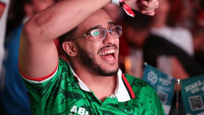 A Mexico supporter in Dubai cheers for his team during their 2-0 win over South Africa. Chris Whiteoak / The National