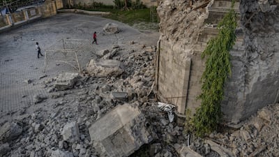 Residents walk past a church that was damaged following a 6.3 magnitude earthquake. Getty Images