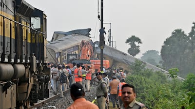 Rescue workers and police officials stand next to damaged coaches following a collision between two passenger trains in Vizianagaram district in the southern Andhra Pradesh state, India, October 30, 2023. REUTERS/R. Narendra NO RESALES. NO ARCHIVES
