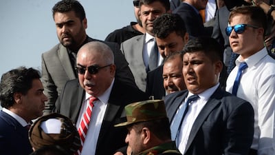 In this photo taken on July 22, 2018, Afghan Vice President Abdul Rashid Dostum (2nd R) arrives at Hamid Karzai International Airport in Kabul. AFP