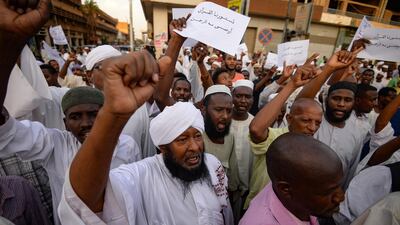 Supporters of Sudanese Islamist movements shout slogans as they rally in front of the Presidential Palace in Khartoum on May 18, 2019. AFP