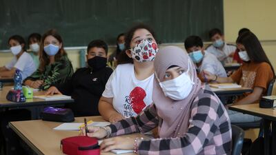 Pupils of the Grade 7 at Bonn's Freiherr-vom-Stein secondary school wear protective masks as school resumes in the federal state of North Rhine-Westphalia following six weeks of summer holidays in Bonn, Germany. Reuters