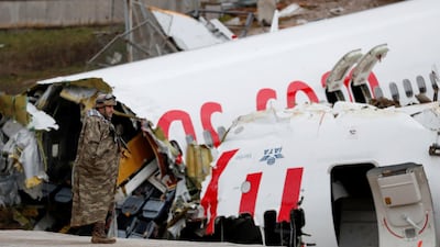 A soldier stands guard near the Pegasus Airlines Boeing 737-86J plane wreckage, after it overran the runway during landing and crashed, at Istanbul's Sabiha Gokcen airport, Turkey. REUTERS