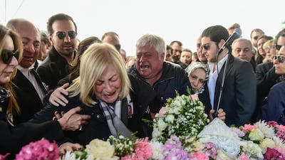 The aunt and father of Mina Basaran, one of the victims of the plane crash, during her funeral in Istanbul. AFP