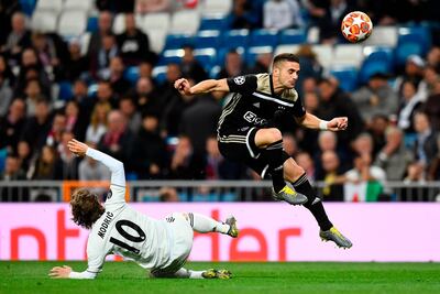 Ajax forward Dusan Tadic, right, evade the challenge of Real Madrid's Luka Modric. AFP