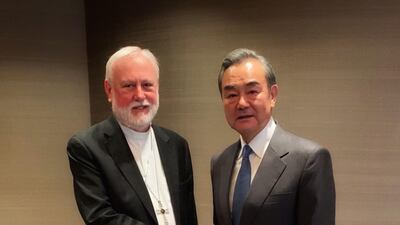 Archbishop Paul Gallagher (left), Holy See Secretary for Relations with States, shaking hands with Chinese Foreign Minister Wang Yi on the sidelines of the Munich 2020 security conference in Munich. AFP