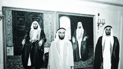 Sheikh Zayed with his brother, Sheikh Hazza bin Sultan Al Nahyan, in front of official portraits during a visit to London in 1957