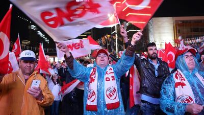 Supporters of Turkey's president Recep Tayyip Erdogan celebrate as they wave national flags during a rally near the headquarters of the Justice and Development Party (AKP) on April 16, 2017 in Ankara. Adem Altan / AFP
