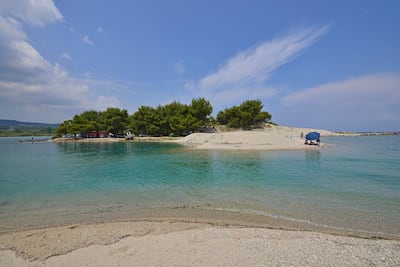 Swimmers enjoy the tranquility of a beach in Pefkohori, Kassandra. Photo by Carlo Raciti
