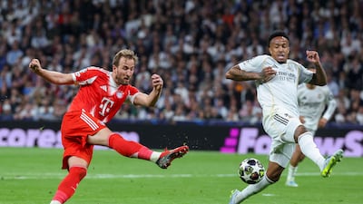 Bayern Munich striker Harry Kane shoots for goal under pressure from Real Madrid's Eder Militao. AFP