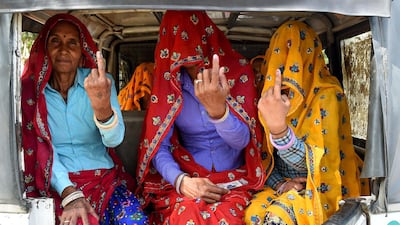 Women in Rajasthan show their ink-stained fingers after voting in the fifth stage of India's general election on May 6, 2019. AFP