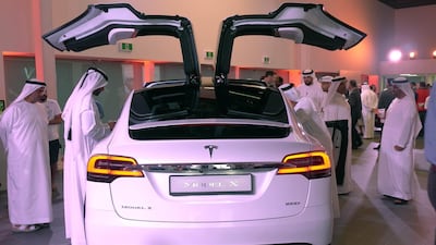Visitors to the Tesla showroom examine the Tesla Model X. New green auto loans will help to catapult sales of zero-carbon emission vehicles, as part of the UAE’s clean energy drive. James Langton / The National