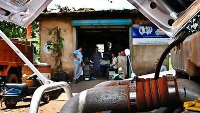Iron ore truck drivers in Goa sit around idly after mining was banned in the state. Gethin Chamberlain for The National