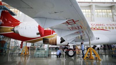 Technicians inspect an ARJ21-700 aircraft at the Comac factory in Shanghai. China launched the ARJ21 project in 2002 in an attempt to break into the Western-dominated aircraft market. Carlos Barria / Reuters