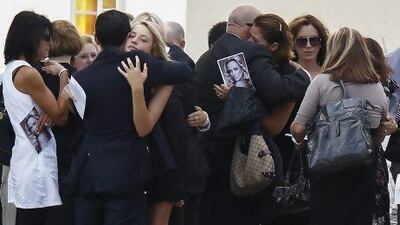 Barry Steenkamp, centre left, father of Reeva Steenkamp is embraced after her memorial service at the Victoria Park Crematorium in Port Elizabeth, South Africa, on Tuesday. Mike Sheehan / EPA