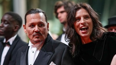 Johnny Depp, left, and director Maiwenn pose for photographers following Jeanne du Barry film premiere. AP