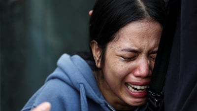 A woman has an excruciating wait for news of her sister outside the station. Reuters
