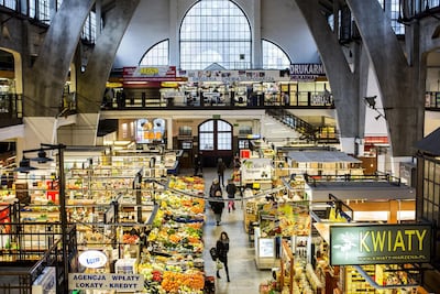 Customers browse vegetable and fruit stalls at an indoor market in Wroclaw, Poland Bartek Sadowski / Bloomberg