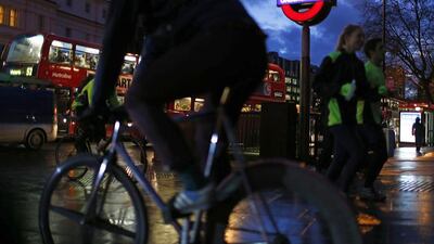 A cyclist passes a London Underground sign. Night-time services are set to start in August. Reuters/Eddie Keogh