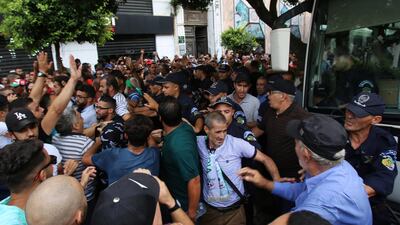 Police officers stand guard as demonstrators try to force their way during a protest rejecting Algerian election announcement for December, in Algiers, Algeria. REUTERS