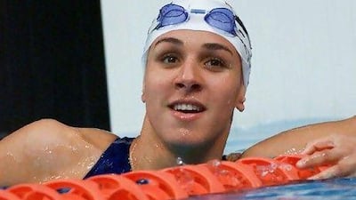 Egyptian Rania el Wani watches the time board after her 50m freestyle heat 22 September 2000 during the Sydney 2000 Summer Olympics. AFP Photo