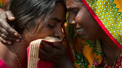Women grieve the death of their relatives in a rainstorm in Bara district, Nepal. AP Photo