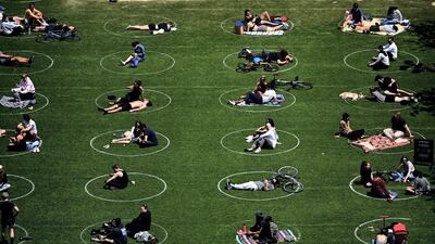 People practise social distancing in New York City's Domino Park. AFP