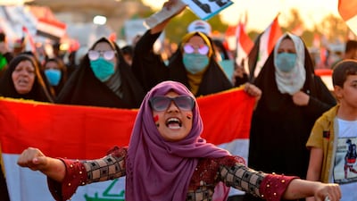 Iraqi women chant slogans and wave their country's national flag during during anti-government protests in the central Iraqi holy city of Najaf. AFP