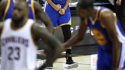 Golden State Warriors guard Stephen Curry, centre, celebrates after the Warriors took the lead at the end of the second half of their Game 3 of the NBA Finals game at Quicken Loans Arena in Cleveland, Ohio. David Maxwell / EPA