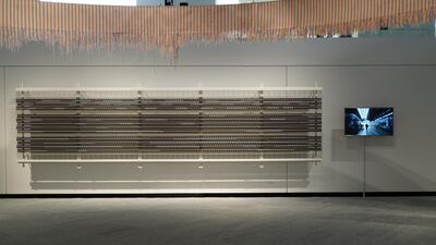 Video from Vikram Divecha's work hangs next to Shafar’s ‘Woven Year’. Courtesy Louvre Abu Dhabi