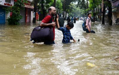 Heavy torrential downpours have brought Mumbai to a virtual standstill flooding streets, causing transport chaos and prompting warnings to stay indoors. Dozens of flights and local train services were also cancelled as rains lashed the coastal city. Punit Paranjpe/AFP Photo