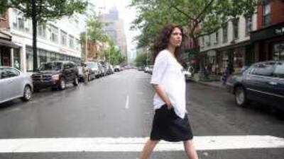 Lena Alhusseini, director of the Arab American Family Support Center, crosses the street ouside the organisation's office in New York.