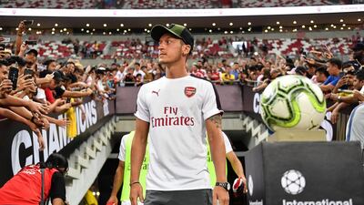 Mesut Ozil was a spectator for Arsenal's friendly with Atletico Madrid in Singapore on Thursday. Getty Images