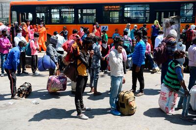 Indian migrant workers and their families gather at Anand Vihar bus terminal in New Delhi on March 29, 2020. AFP