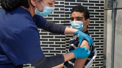 A man receives his Covid-19 vaccine at the Biogenix Labs at G42 in Masdar City, Abu Dhabi. Victor Besa/The National